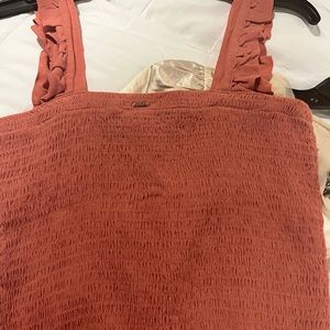 Crop top in a Coral color with ruffle shoulder straps.